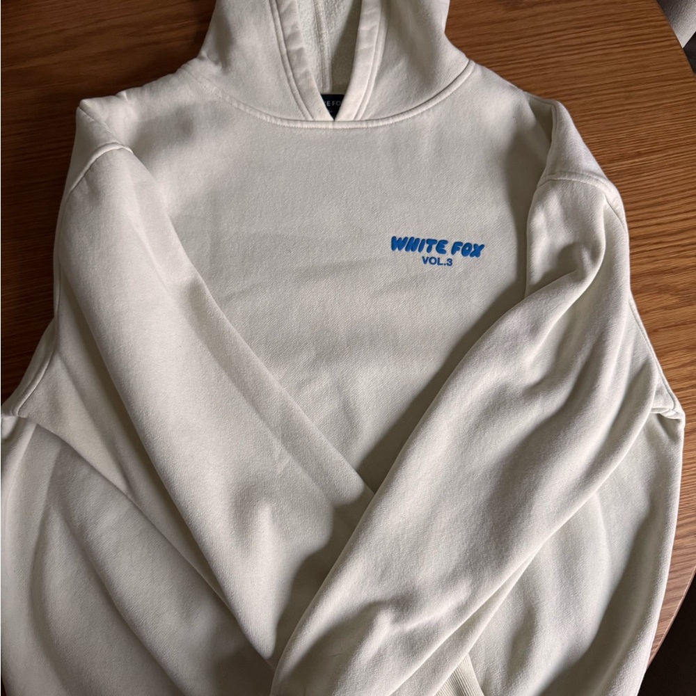 White Fox Boutique Cream Hoodie with Blue Logo